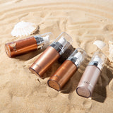 Liquid Highlighter bottles on sandy beach, showcasing body luminizer for a luminous glow on face and legs.
